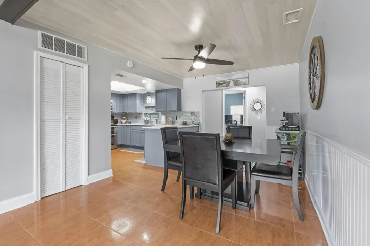 Dining area featuring wood-finish tile flooring and a wood-paneled ceiling