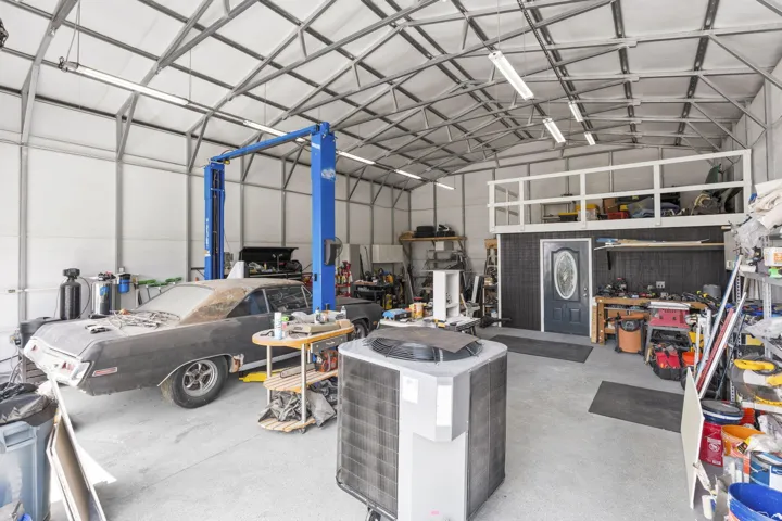 Built-out office in rear corner with storage above