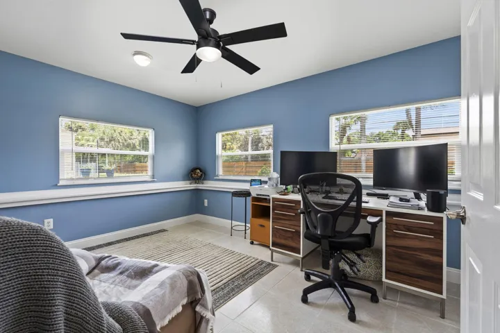 Bright room featuring multiple windows and tile flooring