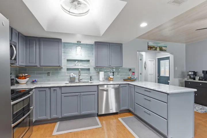 Modern and bright kitchen at the center of the living areas.