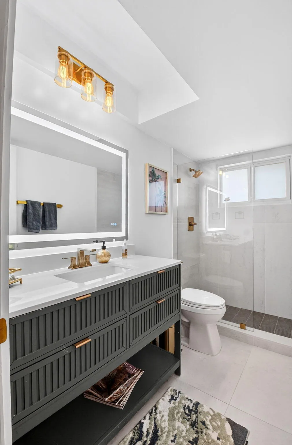 Renovated Bath | Backlit Mirror & Brass Fixtures