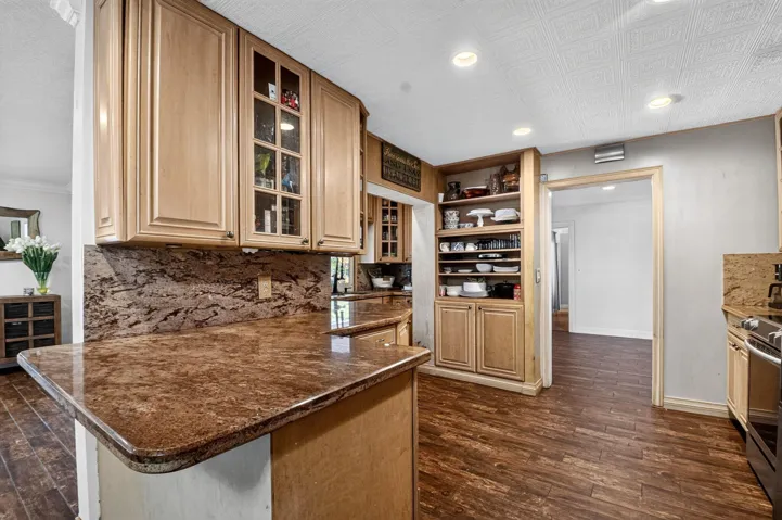 Granite Breakfast Bar & Glass-Front Cabinetry