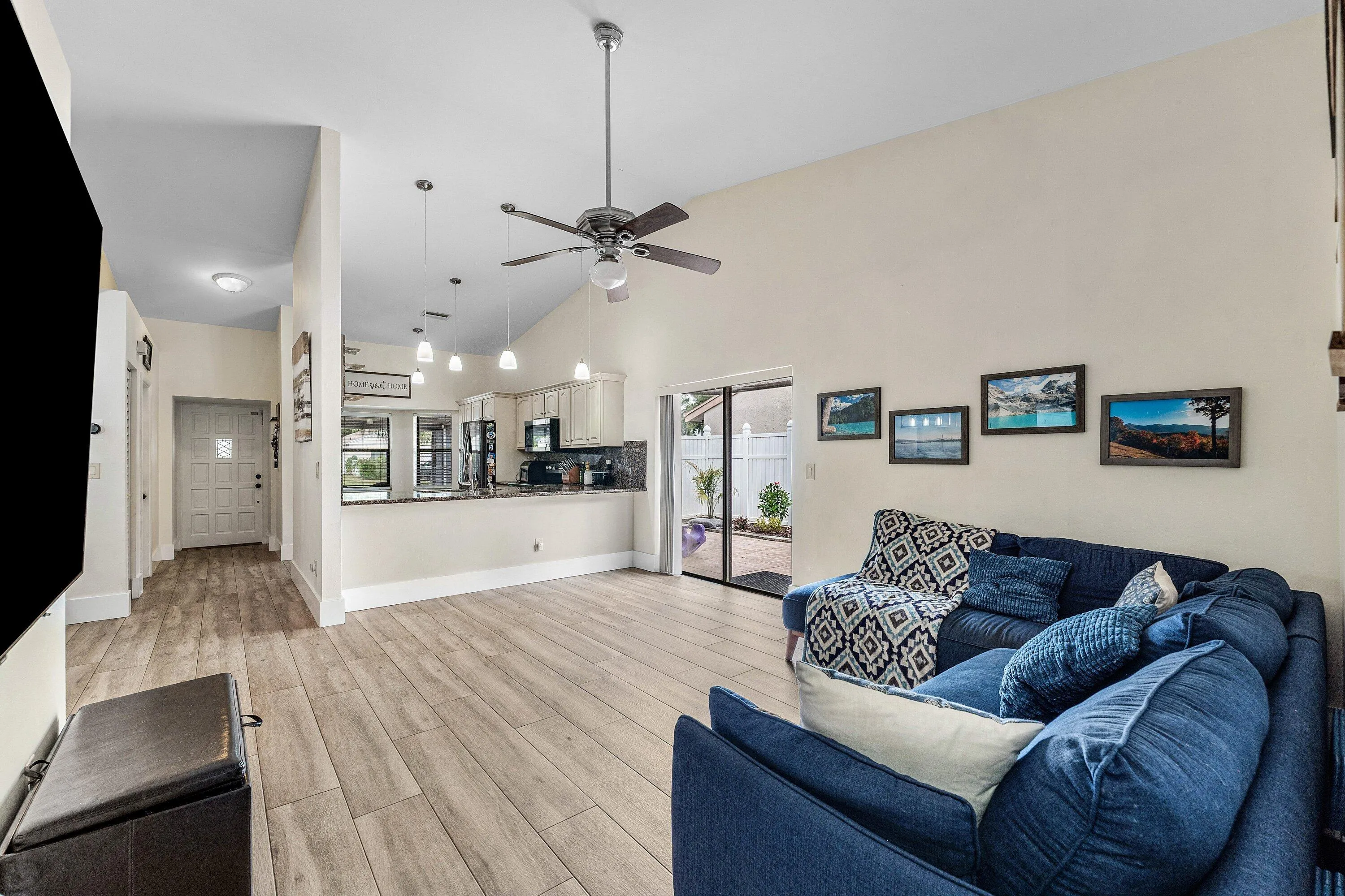 Vaulted ceilings complement the light wood-finish flooring throughout this open living space