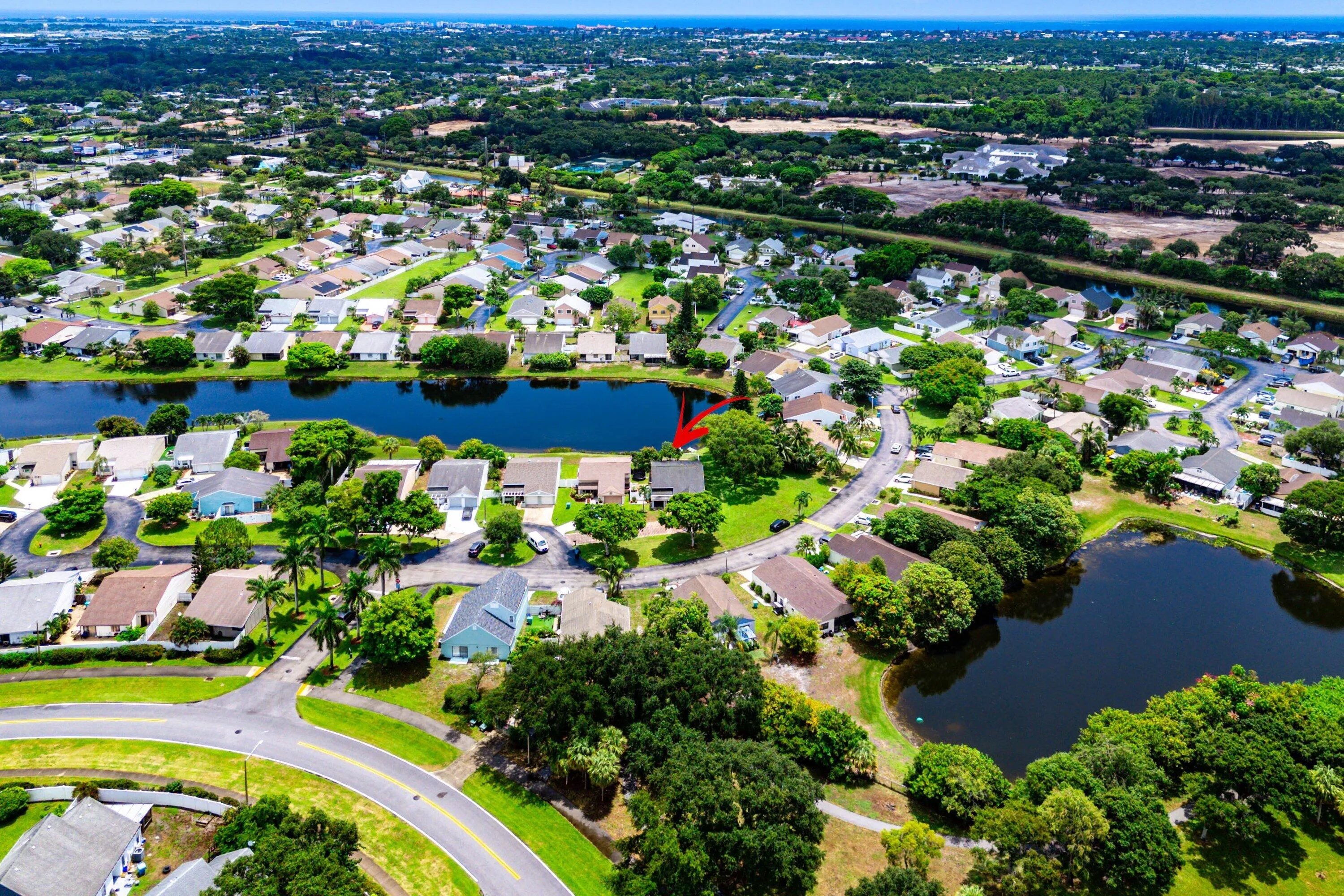 Residential community featuring multiple bodies of water and mature landscaping