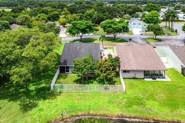 Aerial perspective showcasing two residential properties with lush green landscaping