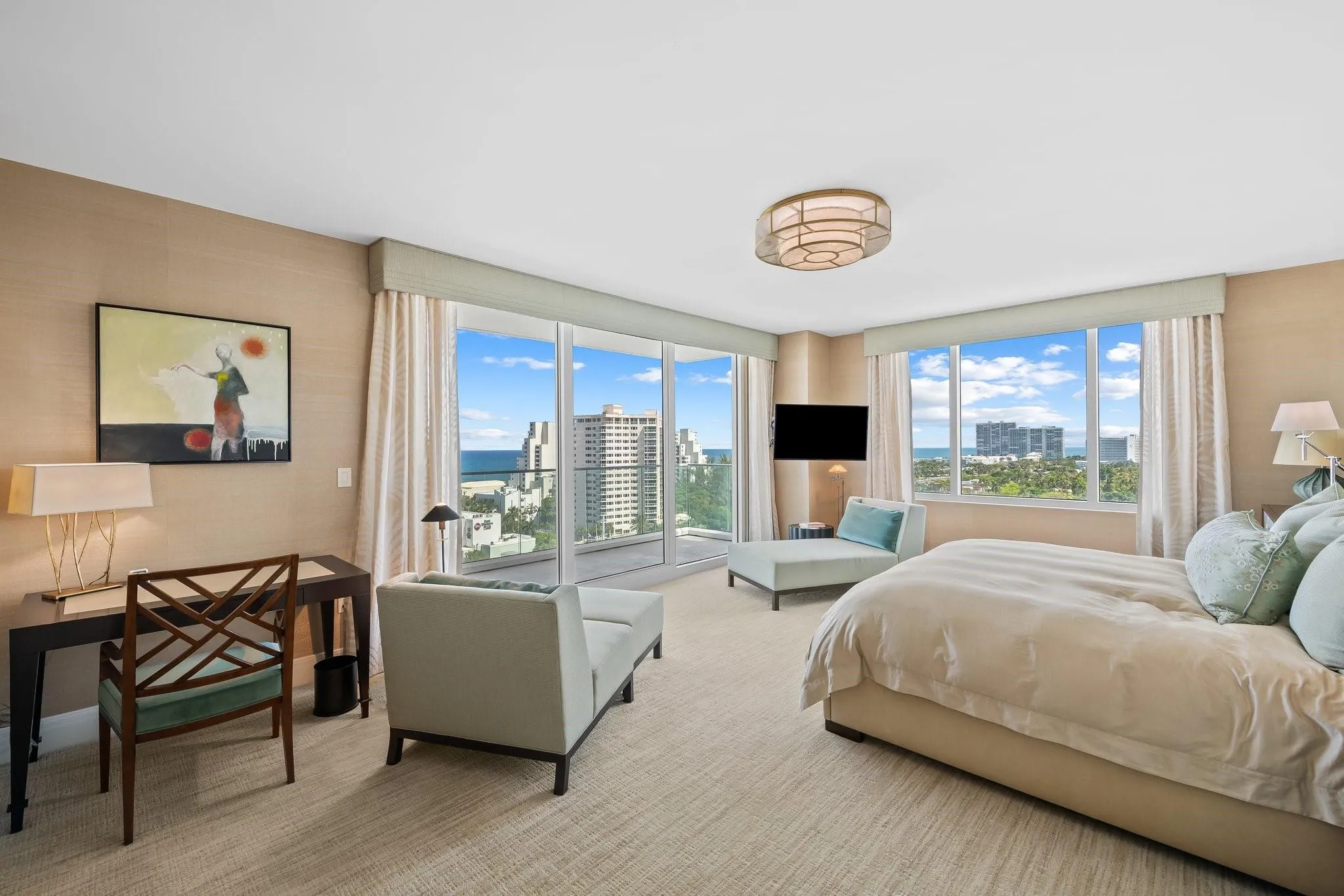 Floor-to-ceiling windows featuring ocean and urban scenery