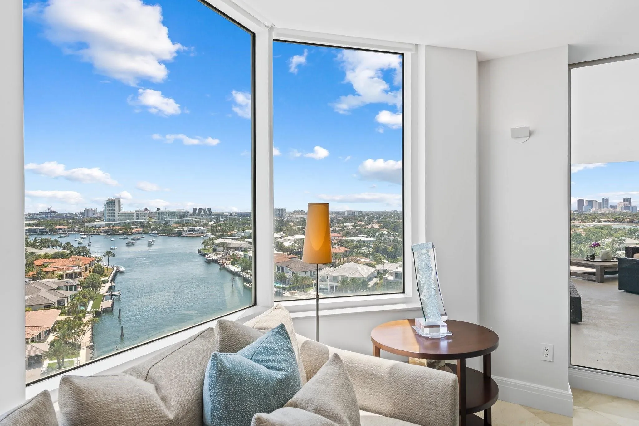 Expansive floor-to-ceiling windows offer panoramic water and city exposures
