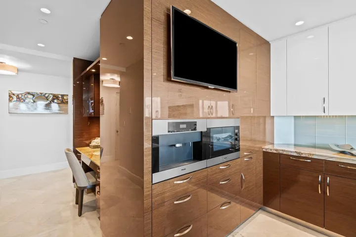 Integrated kitchen appliances featuring a built-in coffee system and microwave