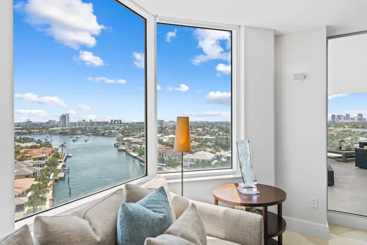 Expansive floor-to-ceiling windows offer panoramic water and city exposures