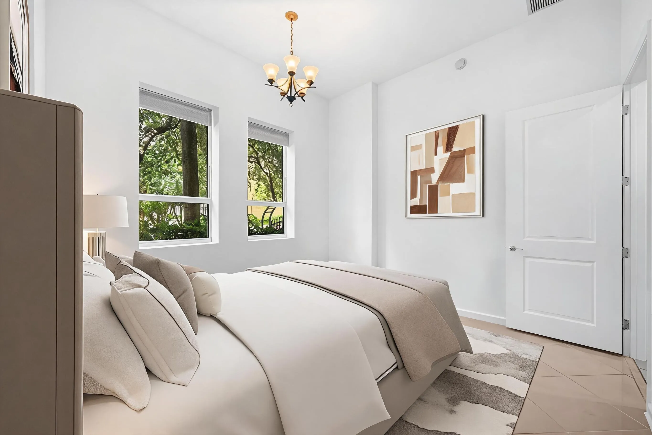 Additional bedroom view featuring dual windows, abundant natural light & tile flooring.
