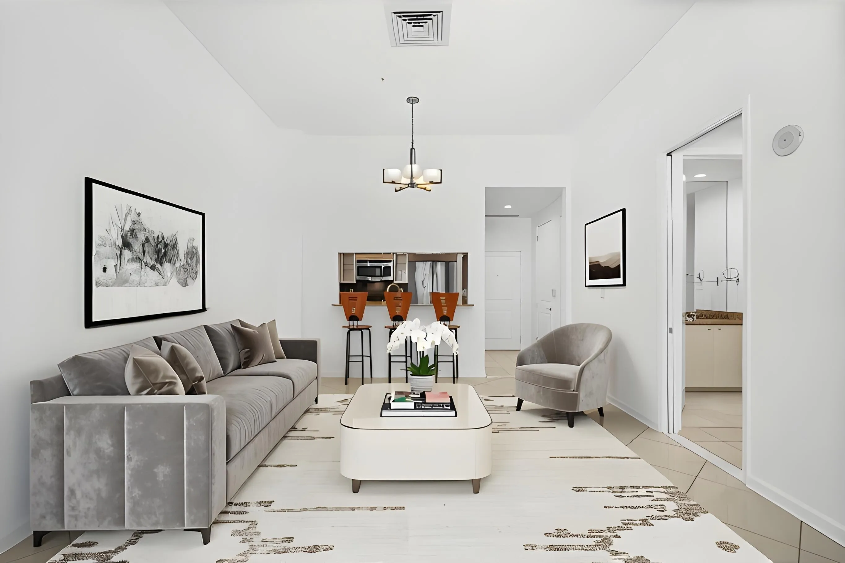 Open living & dining area featuring 11-foot ceilings, tile flooring throughout & a breakfast bar with counter seating.