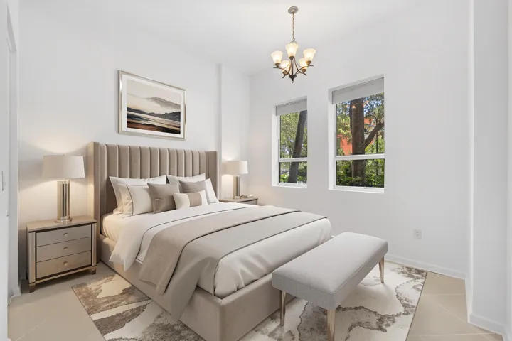 Bedroom with soaring ceilings, tile flooring throughout & dual windows overlooking the landscaped grounds.