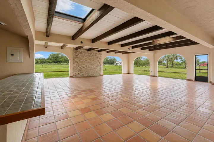 expansive enclosed loggia/potential event space with outdoor kitchen