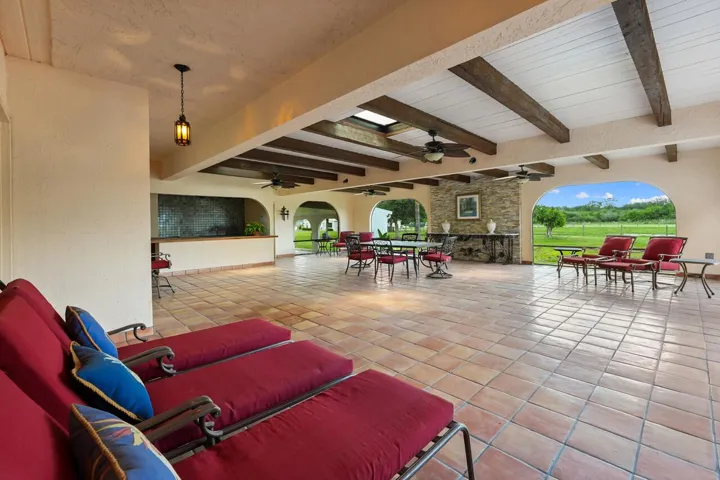 spacious enclosed patio area with outdoor kitchen