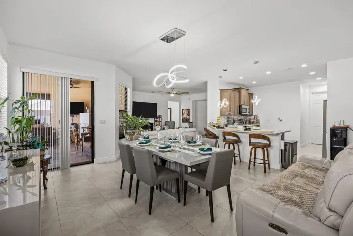 Designed for the way people live today, the open-concept layout seamlessly connects the kitchen, dining, and living spaces while extending naturally to the covered lanai and pool—perfect for everyday living and effortless entertaining.
