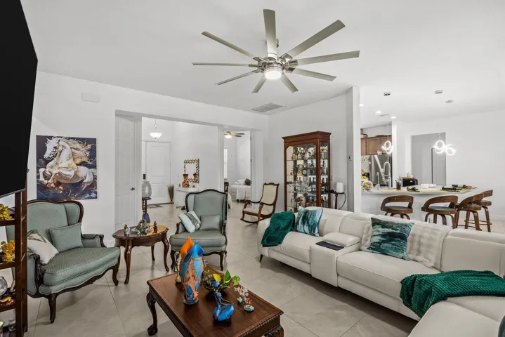 The open-floorplan creates a seamless flow between the kitchen, dining, and living areas, making everyday living comfortable and entertaining effortless. Natural light and volume ceilings enhance the home's bright, airy feel.