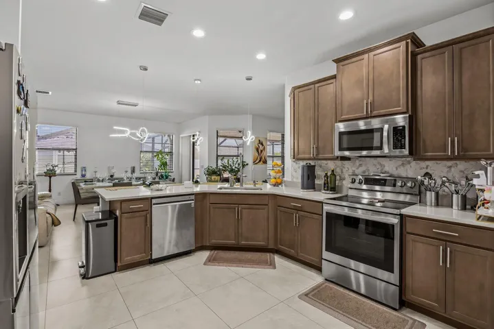 The heart of the home, this thoughtfully designed kitchen features timeless cabinetry, quartz countertops, stainless steel appliances, abundant workspace, and an oversized island that keeps everyone connected while cooking, dining, or entertaining.
