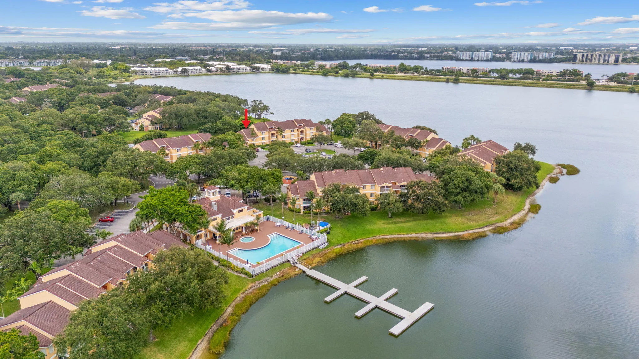 Aerial view highlighting the clubhouse’s location within the community, surrounded by scenic lakes and mature landscaping.