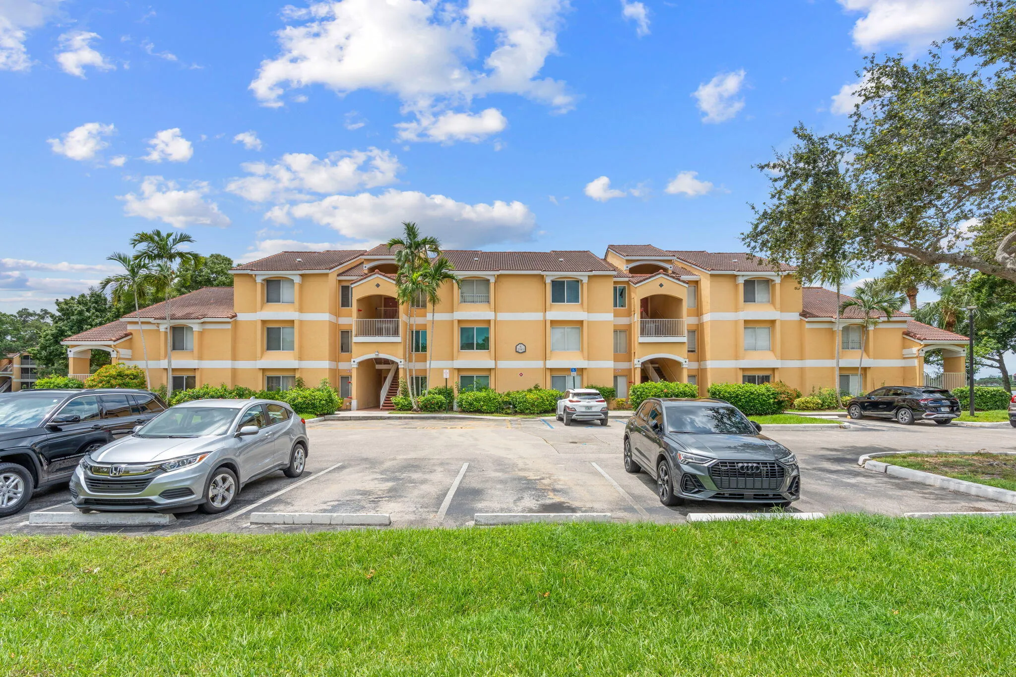 Well-maintained community building with ample resident parking and landscaped grounds.