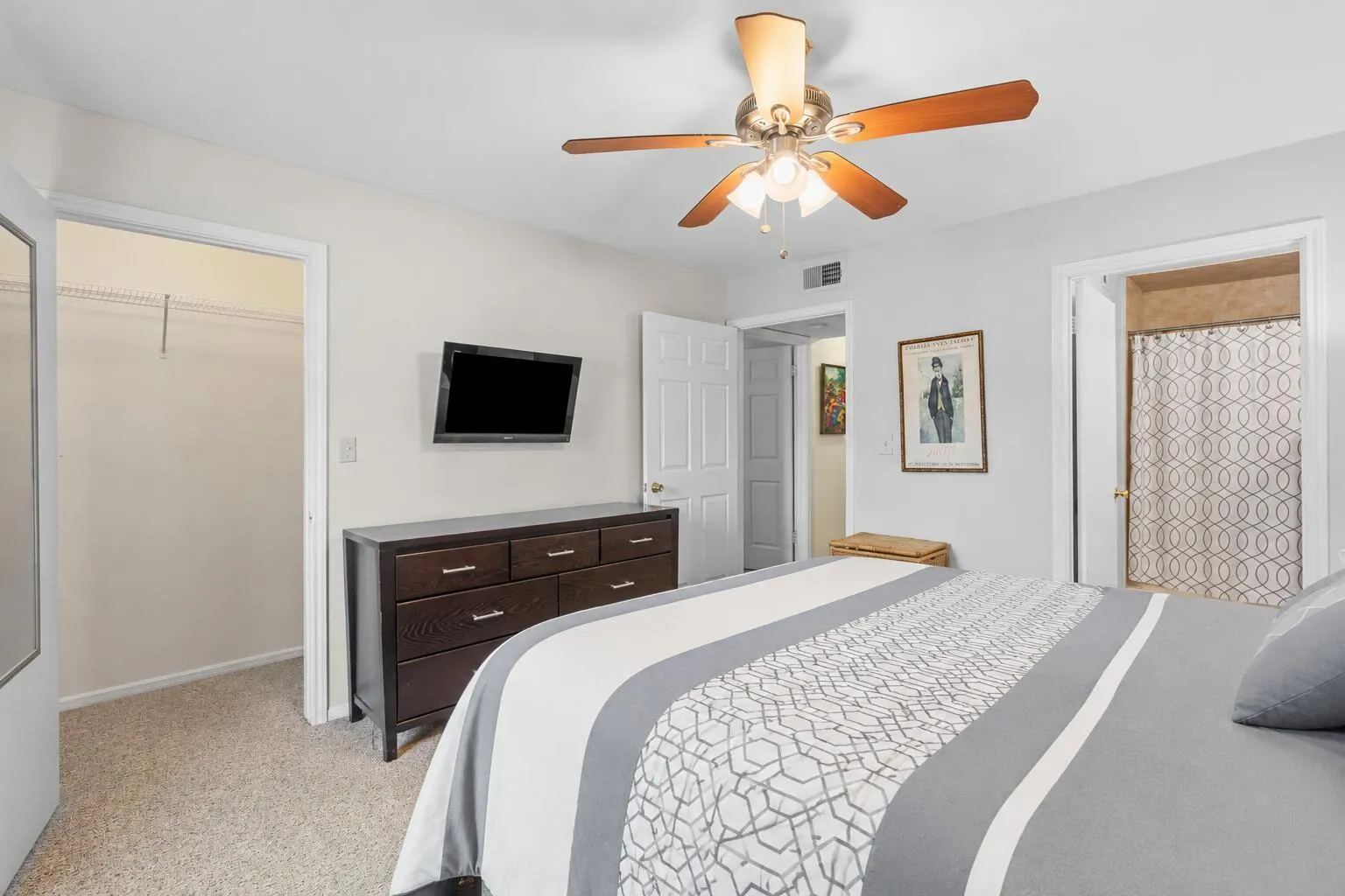 Primary bedroom includes a walk-in closet, ceiling fan, and direct access to the en suite bathroom for added convenience.