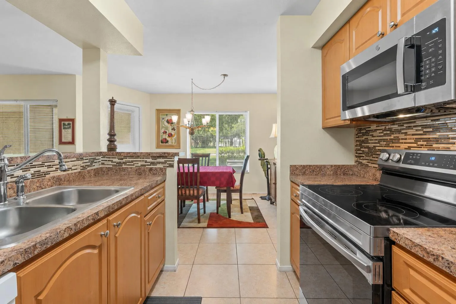 Breakfast bar creates a seamless transition between the kitchen and dining area, making the layout ideal for everyday living and entertaining.