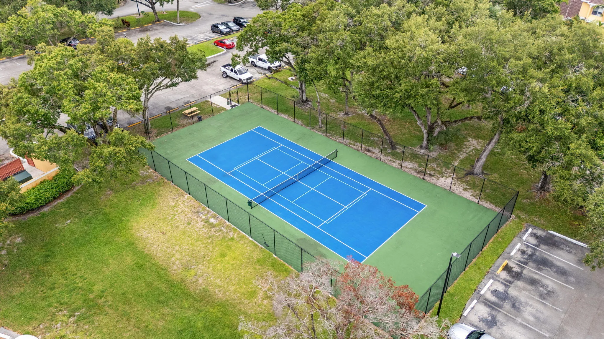 Community tennis court provides a dedicated space for recreation within the neighborhood.