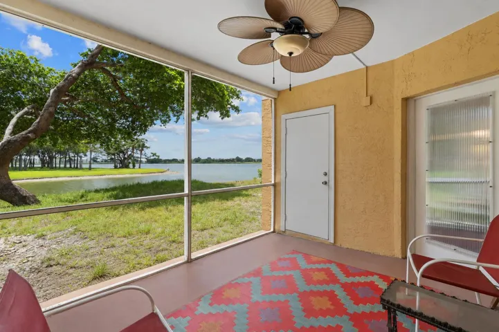 Screened patio provides a comfortable outdoor retreat overlooking the water, complete with a ceiling fan for added comfort.