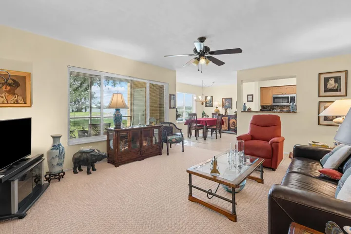 Bright living room provides an open layout with large windows overlooking the lake, creating a welcoming space for relaxing or entertaining.