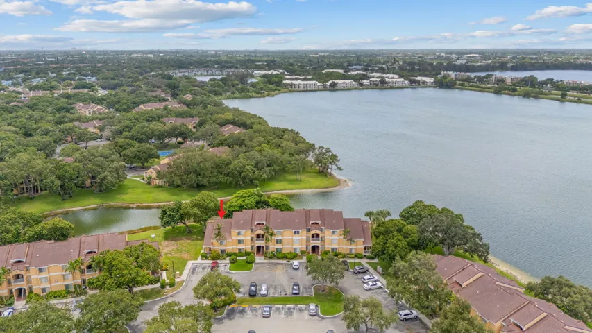 Elevated view highlights the building’s location near the lake and surrounding community amenities.
