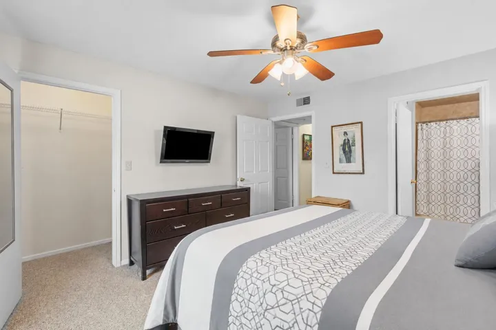Primary bedroom includes a walk-in closet, ceiling fan, and direct access to the en suite bathroom for added convenience.