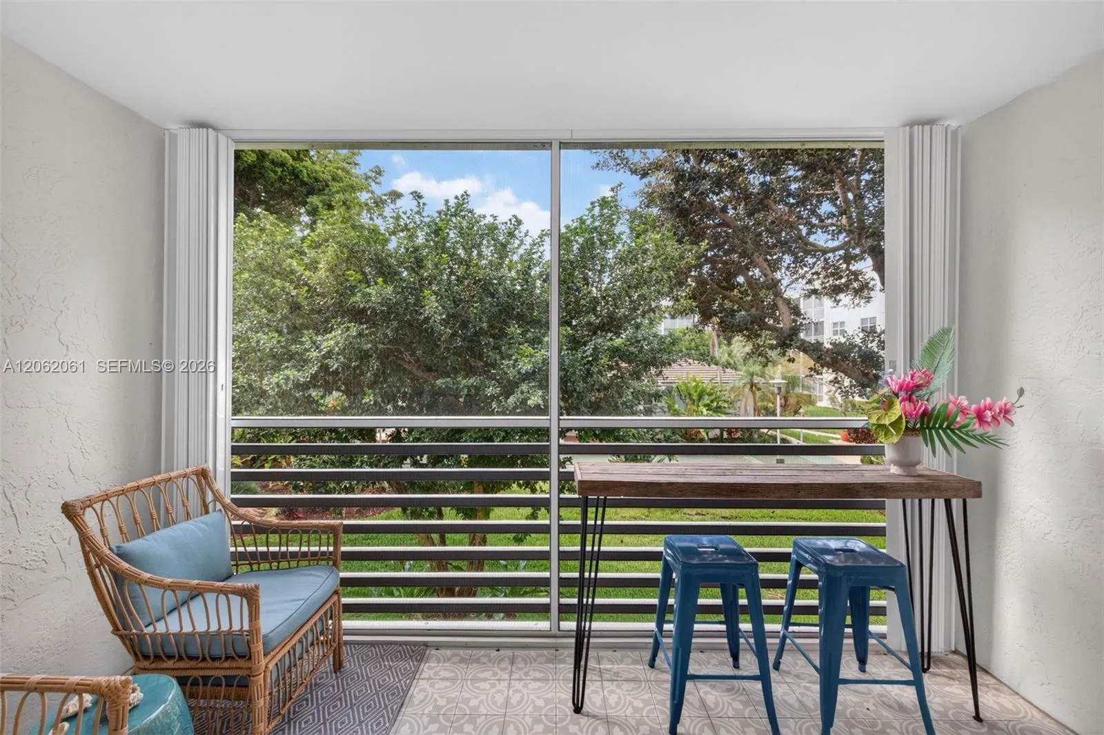Enjoy morning coffee or evening breezes from the screened-in balcony overlooking beautifully lush gardens.