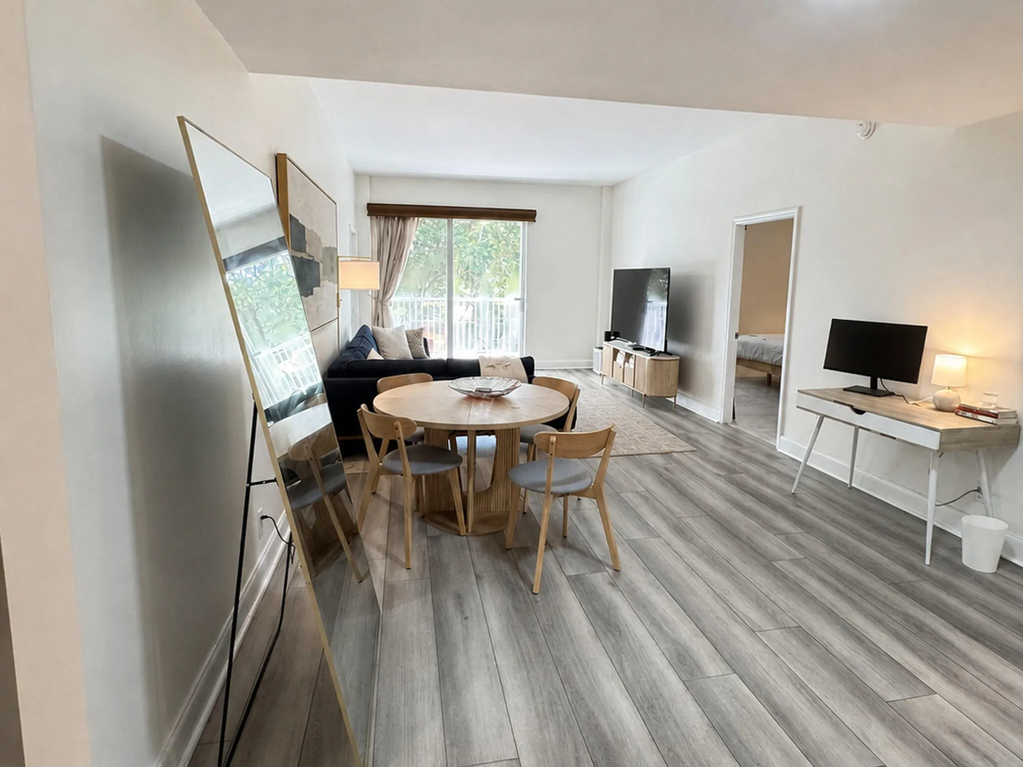 Light wood-finish flooring throughout the open-concept living space