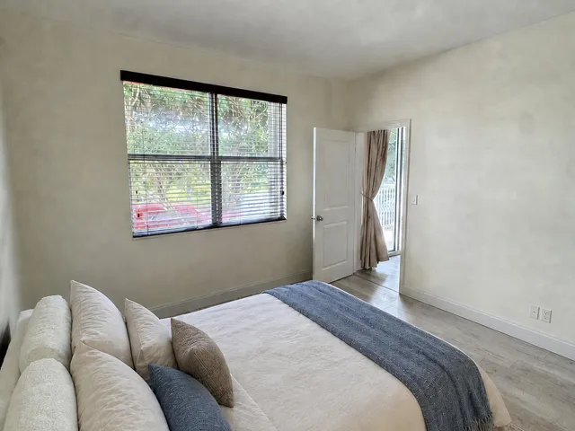 Interior room featuring light-toned walls and wood-finish flooring