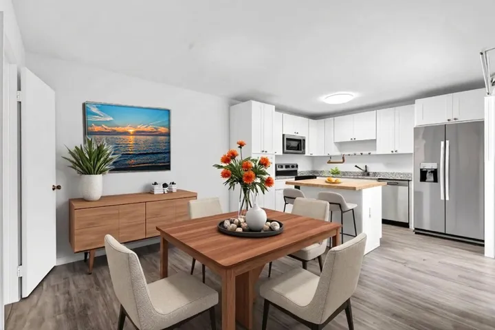 Open-concept kitchen and dining area featuring light wood-finish flooring