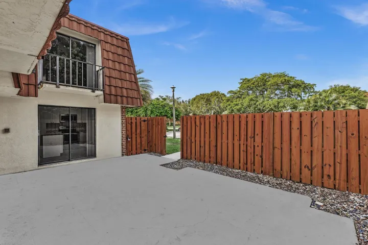 Private patio area featuring a concrete surface and a privacy fence