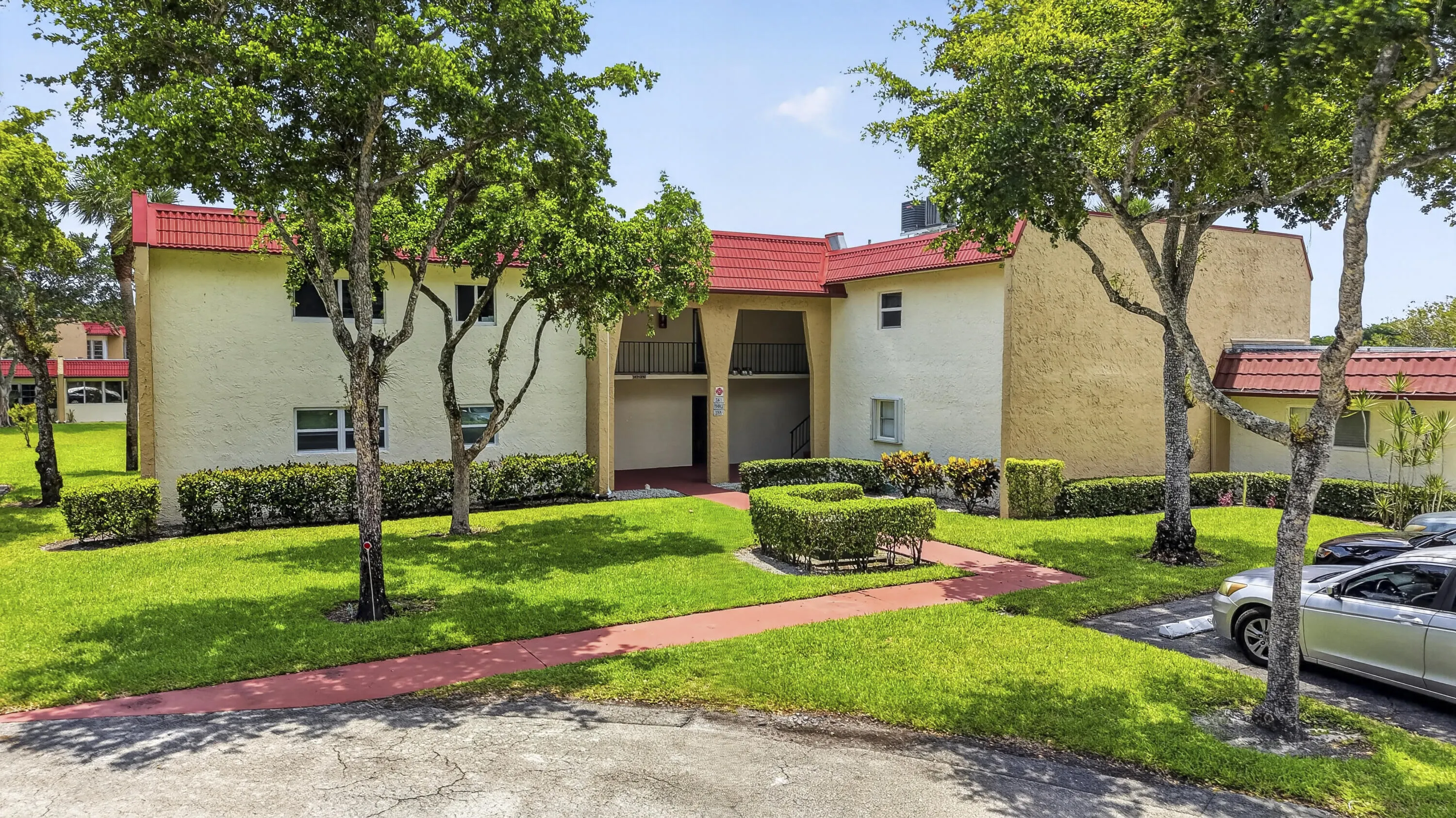 Multi-story stucco exterior with red tile roofing