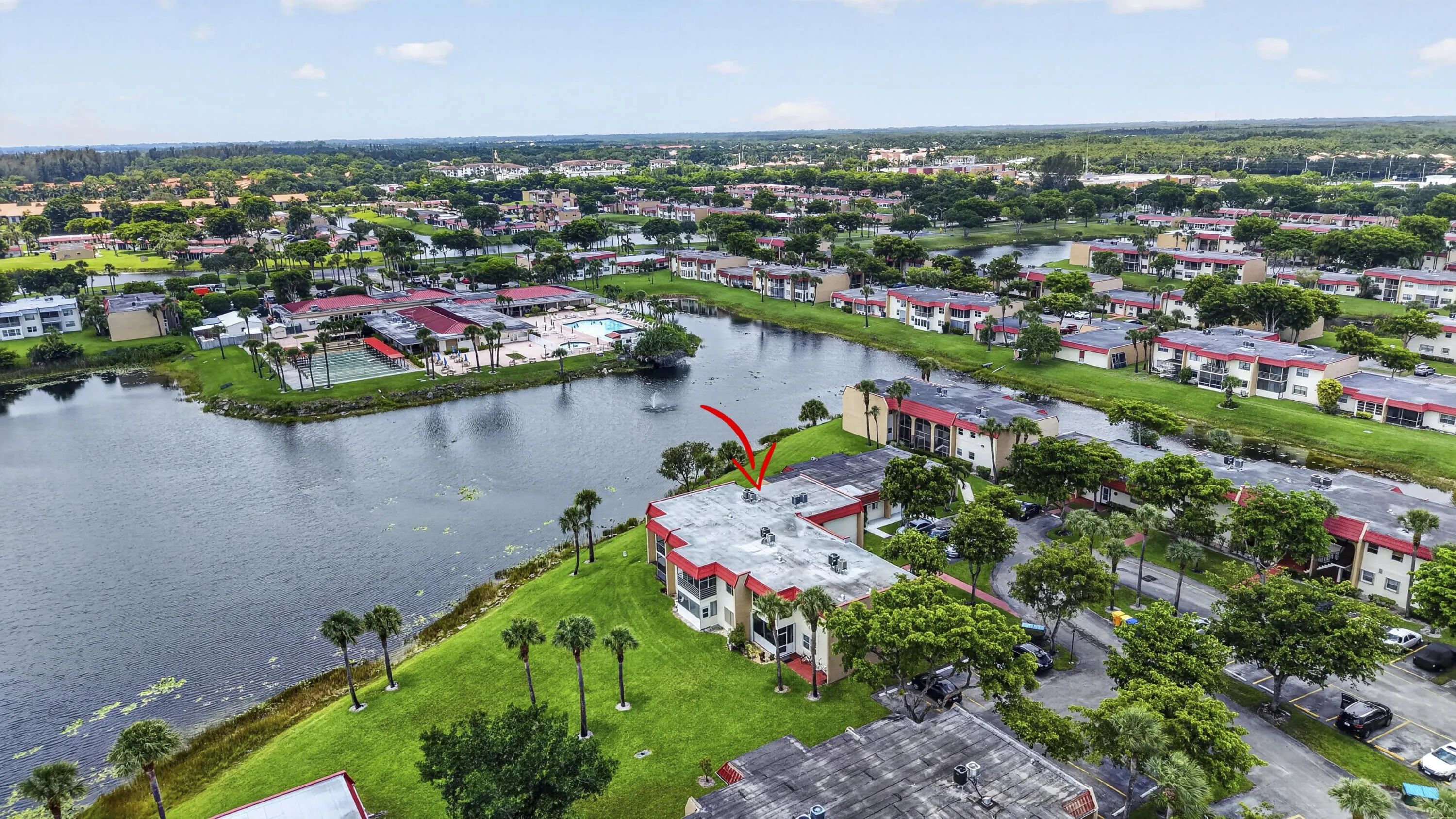 Waterfront community featuring multi-story buildings with red tile roofs