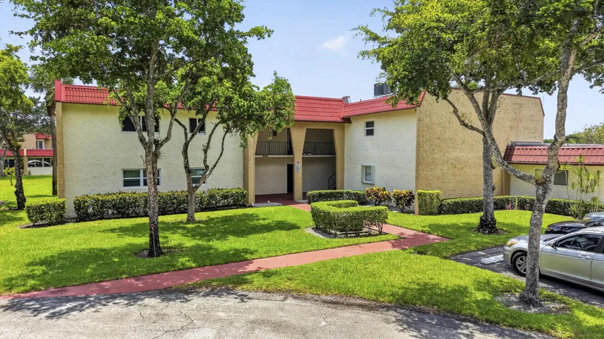 Multi-story stucco exterior with red tile roofing