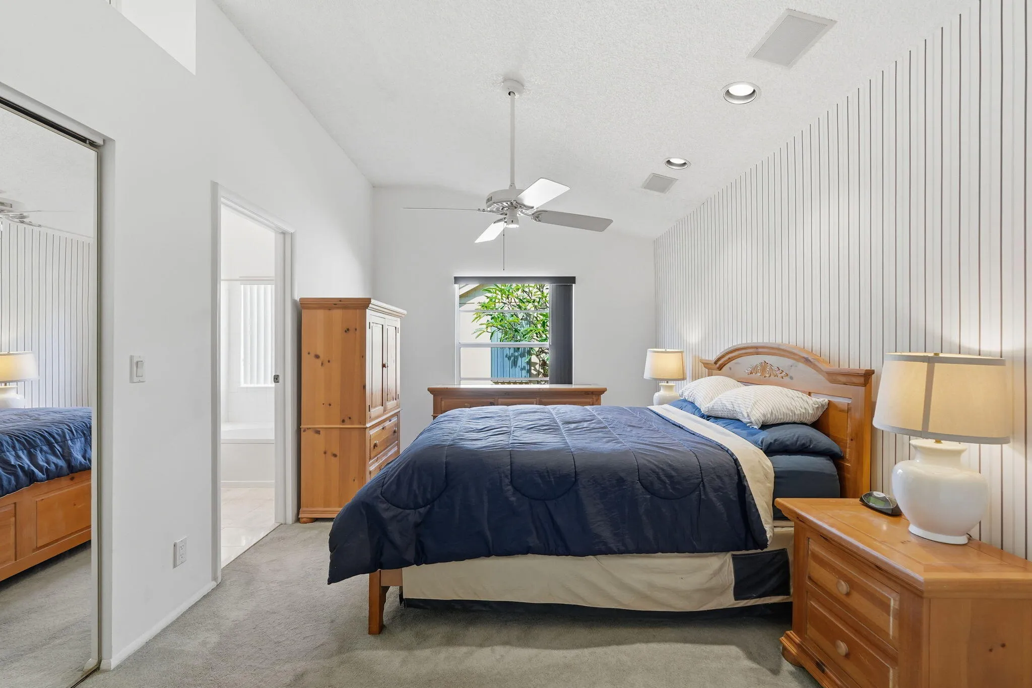 Vaulted ceiling bedroom with recessed lighting and a ceiling fan