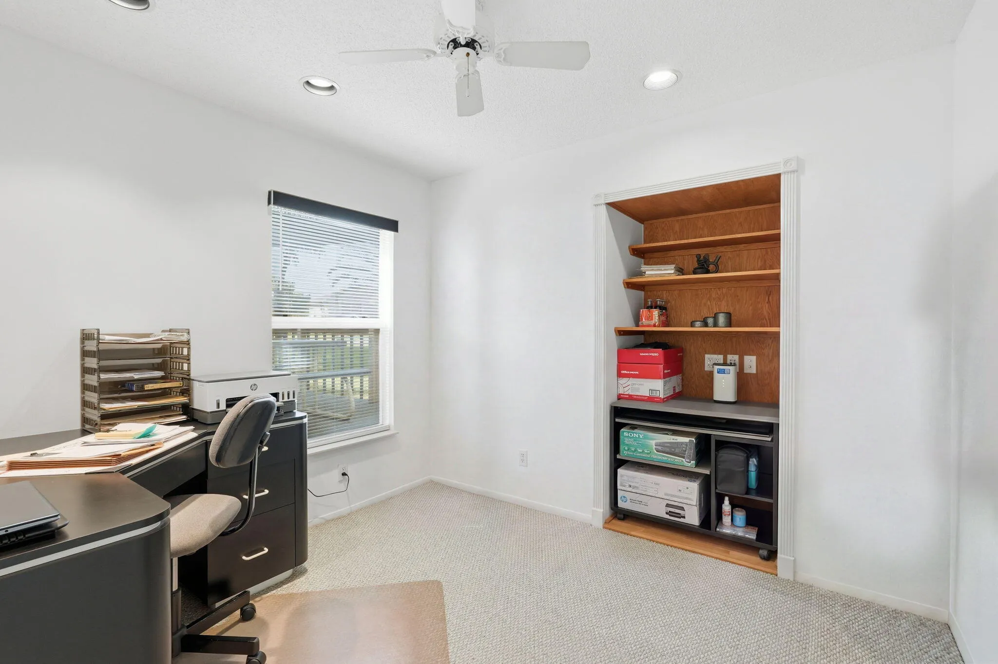 Carpeted room featuring a ceiling fan with light, recessed lighting, and a window with blinds