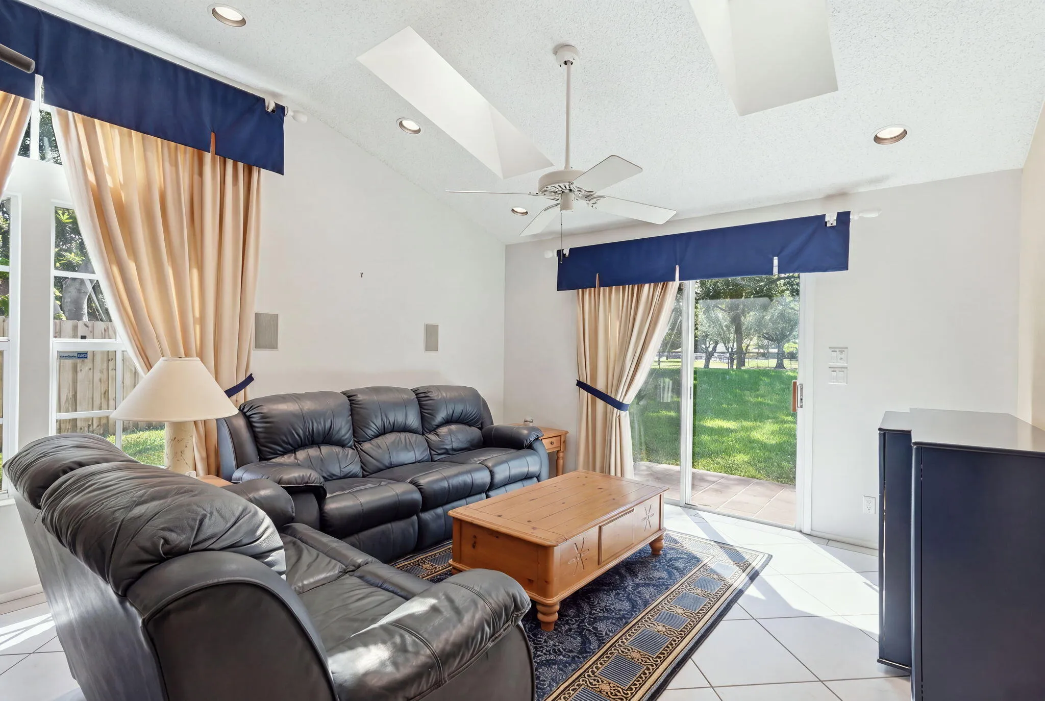 Vaulted ceiling with recessed lighting and a ceiling fan