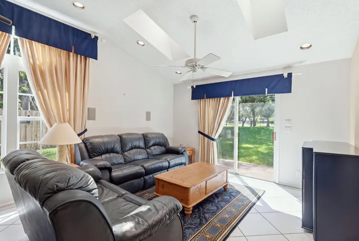 Vaulted ceiling with recessed lighting and a ceiling fan