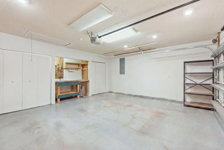 Spacious garage featuring concrete flooring and ample overhead lighting