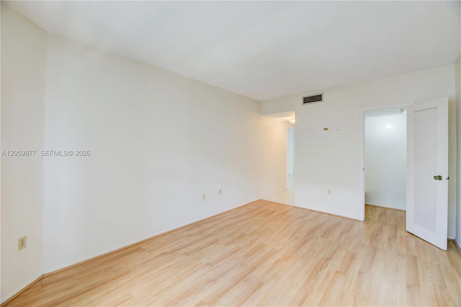 private feeling bedroom with closets and a bathroom