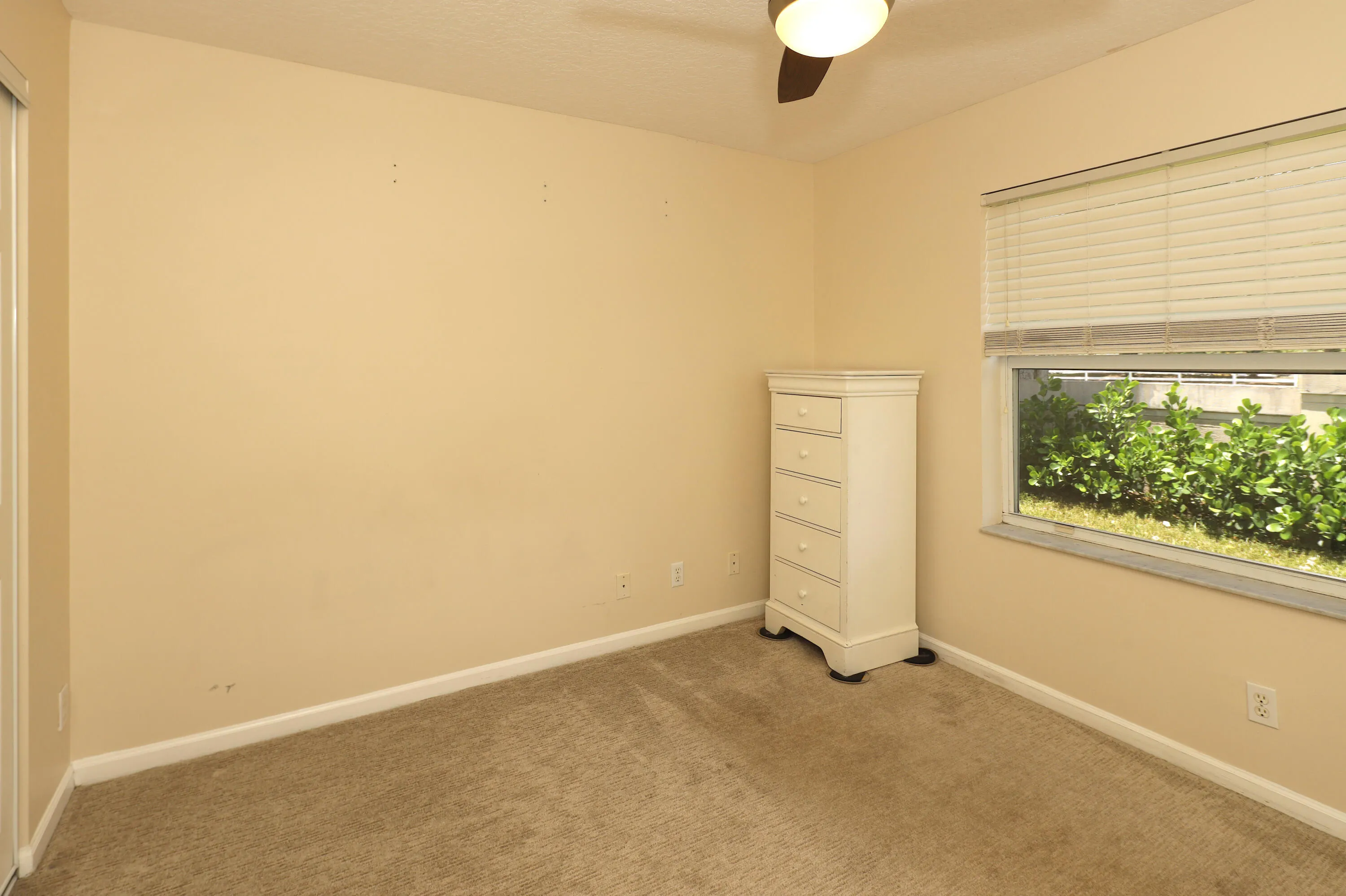 Alternate view of the second bedroom highlighting the generous floor space and functional layout.