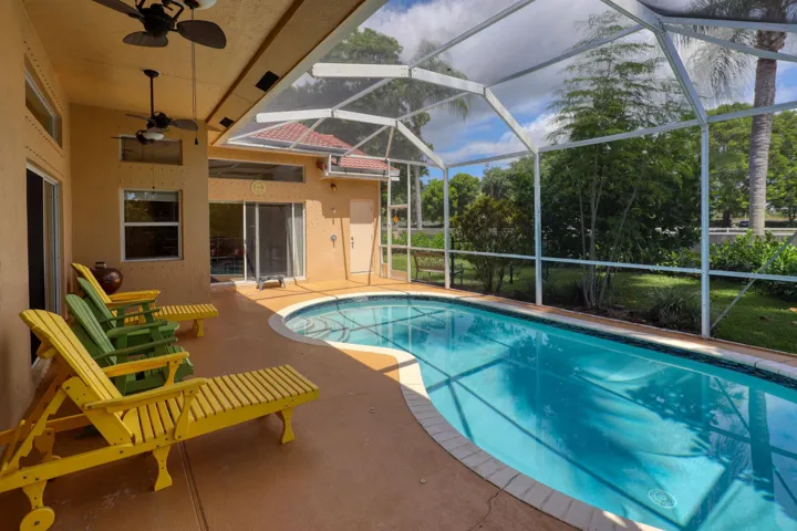 Enjoy Florida living in the screened pool area with a covered lanai, ceiling fans, and plenty of space for relaxing or entertaining family and friends year-round.