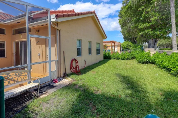Fenced side yard offering a dedicated pet area with room to play while enjoying additional outdoor living space.