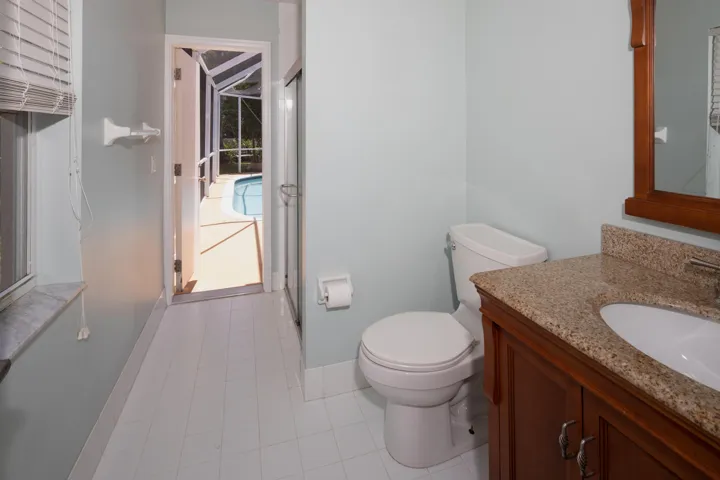 Convenient cabana bathroom with direct access to the pool area, perfect for outdoor entertaining and guests.
