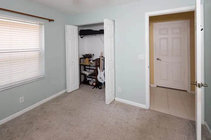 Bright third bedroom with ample closet space and flexible use for family, guests, or a home office.
