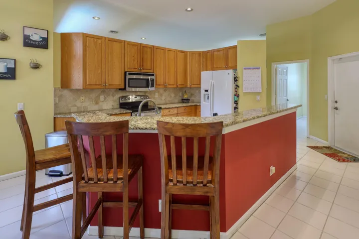 Breakfast bar overlooking the kitchen, creating the perfect gathering space for casual meals and entertaining.